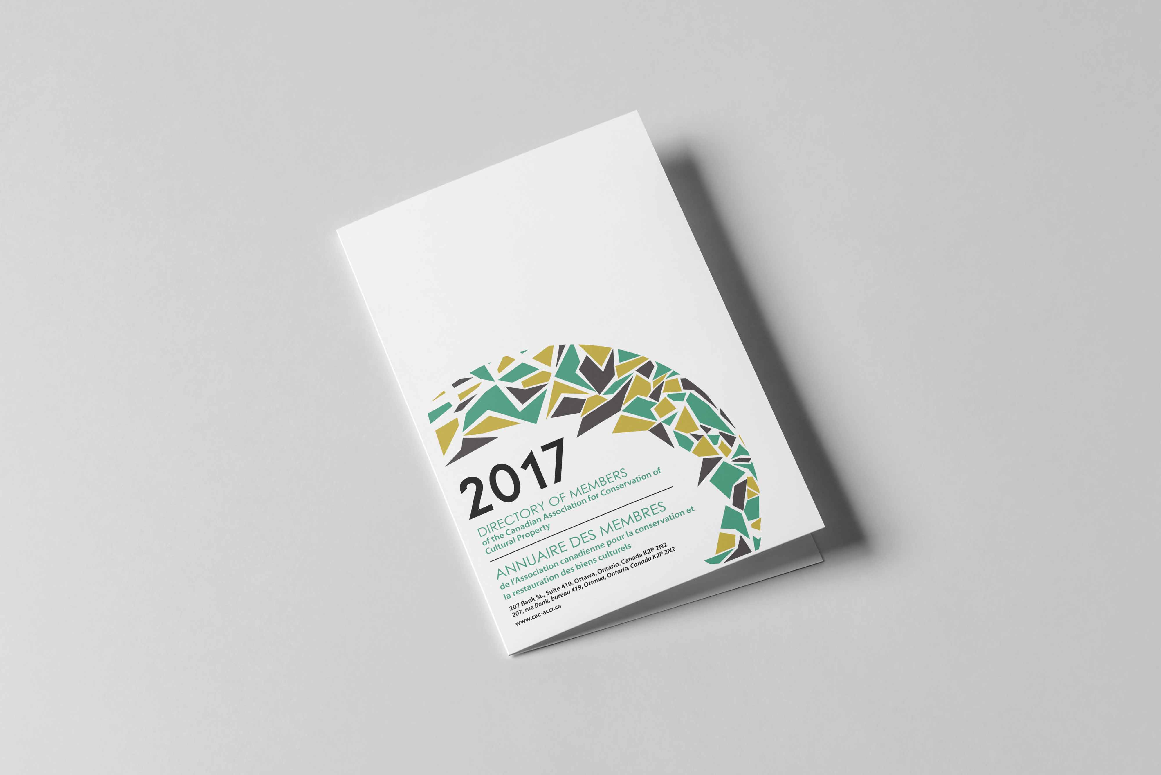 CAC06 Mock-up of member directory booklet on grey background. Design includes the title of the directory in sans serif font framed in the black, teal and gold mosaic in the bottom left-hand corner.