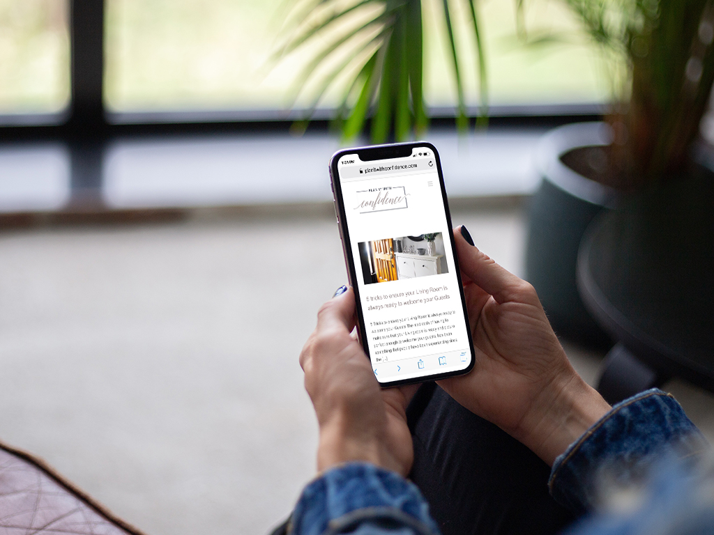 PIWC Mobile women looking at cell pone sitting on a couch