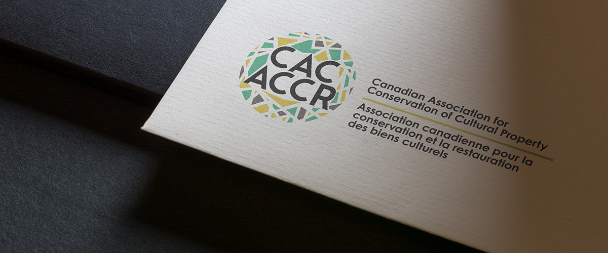 CAC – Topper Mockup of rebranded colour logo for CAC-ACCR on stationery. Showing bottom lefthand corner on black background.